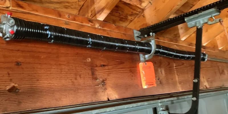 Garage door spring repair and replacement — gray sectional garage door